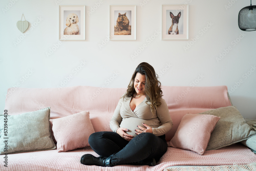 Positive pregnant woman relaxing on sofa Positive pregnant woman relaxing on sofa