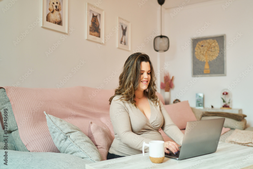Happy pregnant woman with laptop Happy pregnant woman with laptop