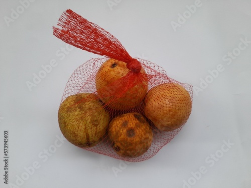 guava (Psidium guajava L) in orange basket top view on white background photo