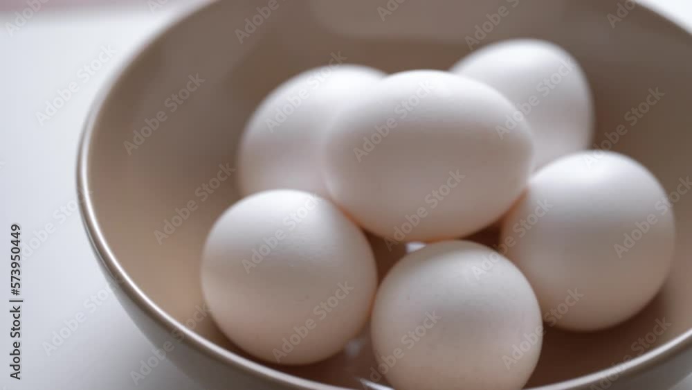 Hand Takes White Egg From Eggs Packed. Chicken egg rotates on a white background. Close-up of an egg. Fresh Protein Food. Chicken Eggs In Eggshell Cardboard Box. Chicken Coop Package. Raw Food Breakfa Hand Takes White Egg From Eggs Packed. Chicken egg rotates on a white background. Close-up of an egg. Fresh Protein Food. Chicken Eggs In Eggshell Cardboard Box. Chicken Coop Package. Raw Food Breakfa
