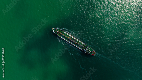 Oil Ship tanker or Liquid fied Petroleum Gas (LPG) sailing in green sea aerial top view photo
