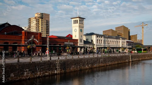 Malmo Central railway Station, water canal, blurred traffic at bright sunny day photo