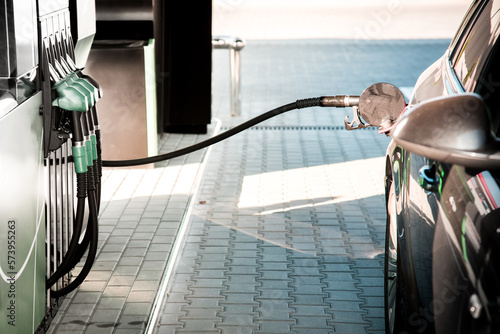 Obraz na płótnie Image of a car gas station with a gun stuck in the car tank and a fuel hose w salonie