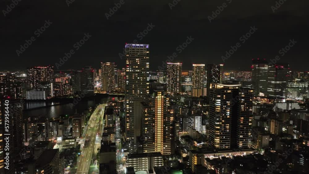 Aerial view of tall residential and office buildings in modern city at night Aerial view of tall residential and office buildings in modern city at night