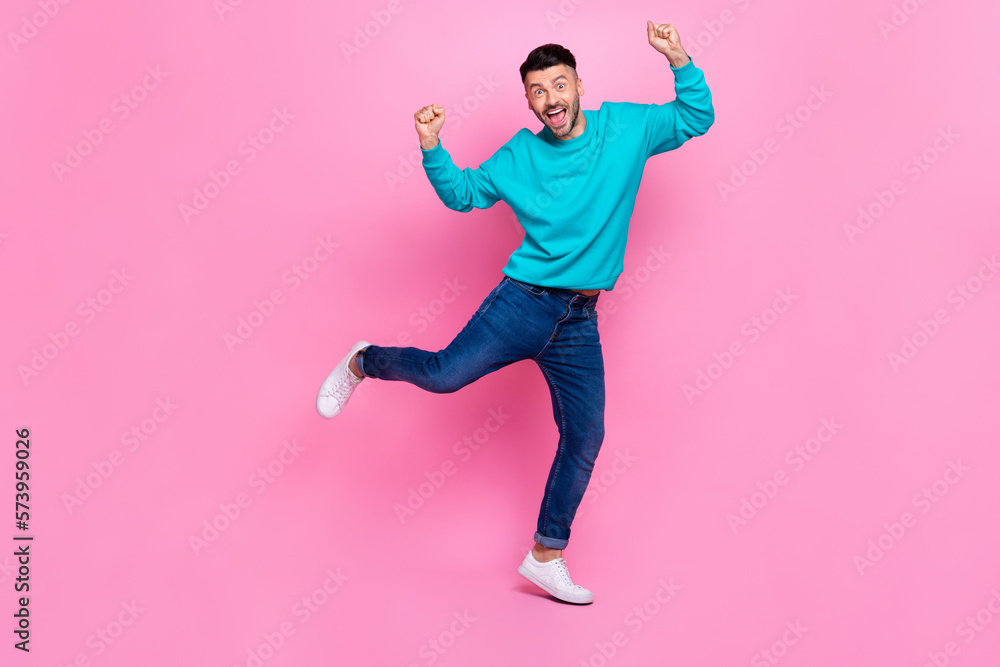 Full body photo of young attractive male raise fists celebrate luck excited wear trendy blue clothes isolated on pink color background