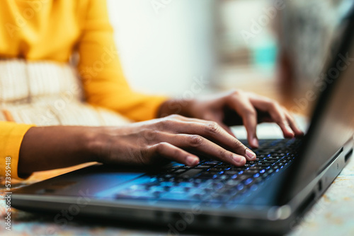 Close up hands typing using laptop computer. Woman browsing online working freelance blogger sharing information on pc. Unrecognizable person. photo