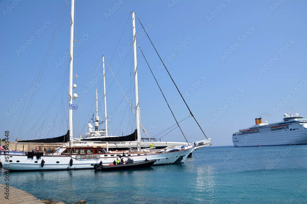 seaport with yachts and ferry on the mediterranean sea in sunny day, greek island Rhodes
