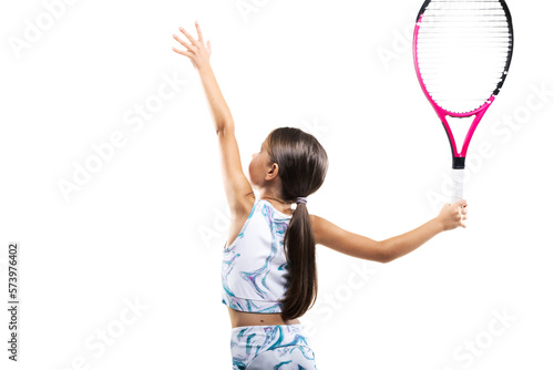Young female tennis player. Little girl posing with racket and ball isolated on white background.