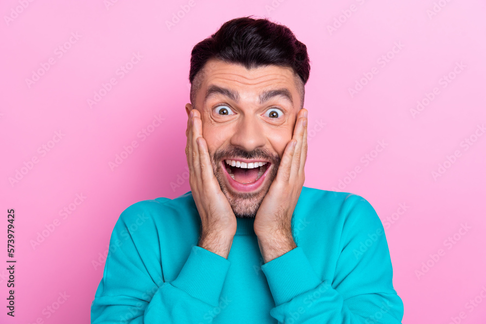 Portrait photo of young funny guy wear trendy blue jumper touch cheeks crazy reaction unexpected new product promo isolated on pink color background Portrait photo of young funny guy wear trendy blue jumper touch cheeks crazy reaction unexpected new product promo isolated on pink color background