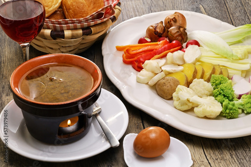 Bagna cauda(Italian Piedmont cuisine)  is a hot dip made from garlic and anchovies. 
The dish is served with raw or cooked vegetables typically used to dip into it. photo