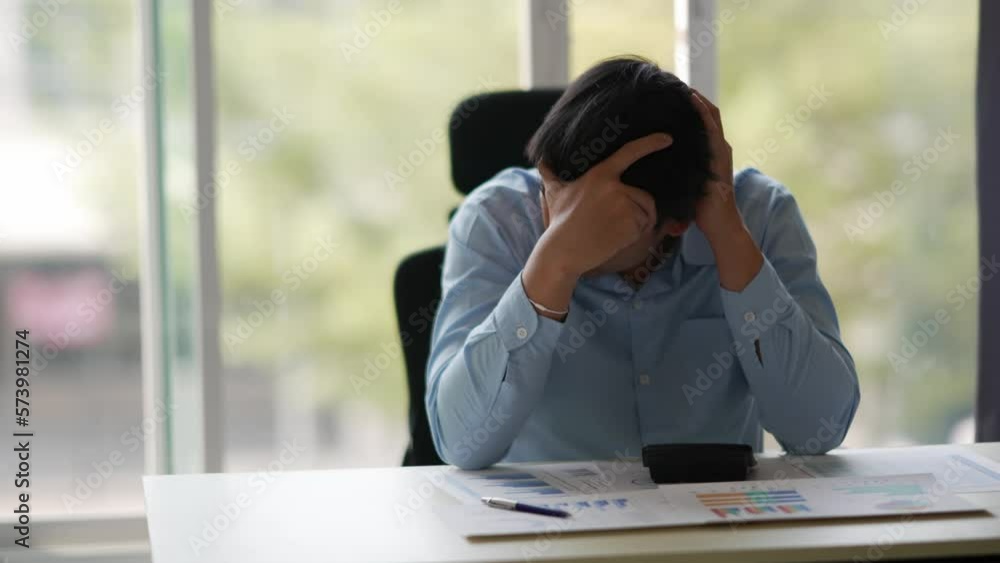 Businessman suffering from a headache or migraine due to stress caused by deadlines and work pressures. Businessman suffering from a headache or migraine due to stress caused by deadlines and work pressures.