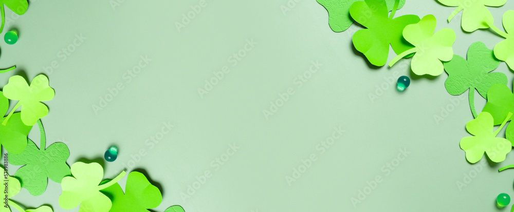 St. Patrick's Day banner. Paper clover leaves on colored background with copy space St. Patrick's Day banner. Paper clover leaves on colored background with copy space