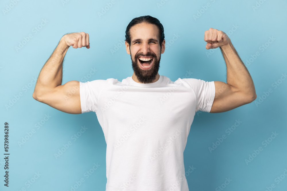 Man bodybuilder showing biceps raising strong arms, proud of muscular build, leadership. Man bodybuilder showing biceps raising strong arms, proud of muscular build, leadership.