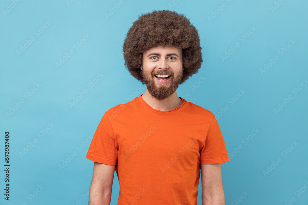 Man looking at camera with toothy smile and happy facial expression, being in good mood. Man looking at camera with toothy smile and happy facial expression, being in good mood.