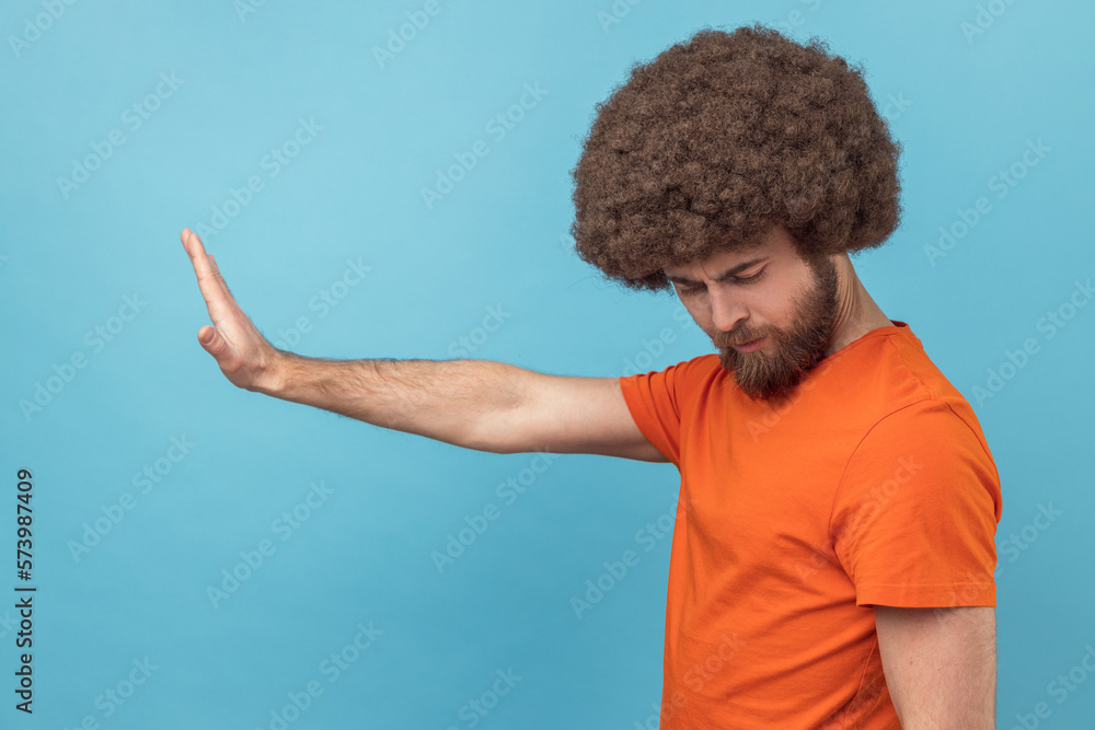 Side view of man making stop gesture showing palm of hand, conflict ...