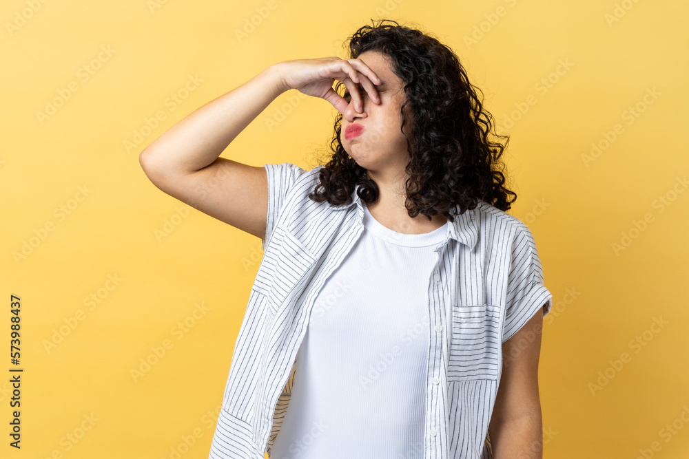 Woman pinching nose, stop breathing bad odor, disgusted by smell of