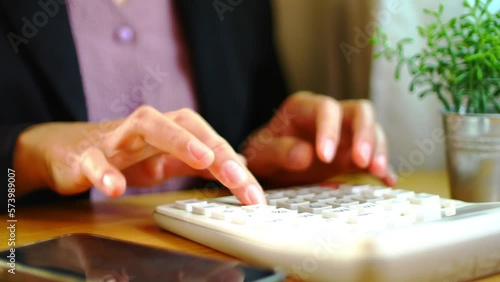 woman calculating numbers using a calculator 