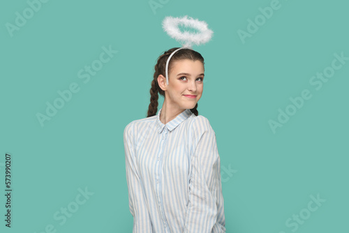 Fotografie Pretty lovely friendly angelic teenager girl with nimb over head, coquetry with