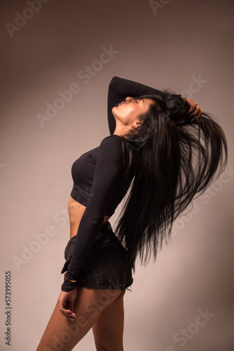 black-haired girl dressed in black shorts and a tank top. sexy ass. wish . excitation.