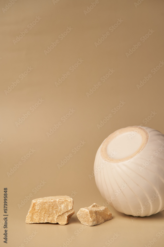 Vertical image, round porcelain podium for product presentation, complemented by natural stones. An empty porcelain podium for the presentation of goods. With a space to copy. High quality photo Vertical image, round porcelain podium for product presentation, complemented by natural stones. An empty porcelain podium for the presentation of goods. With a space to copy. High quality photo