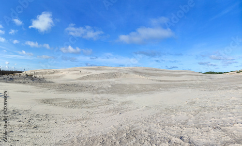 panoramic view of Lacka dune in Slowinski National Park. white sandy hill against a blue sky. Leba, Poland