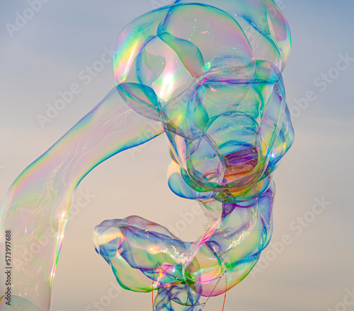 Sunlight refracting through Large colorful bubbles on the ocean coast during sunset.