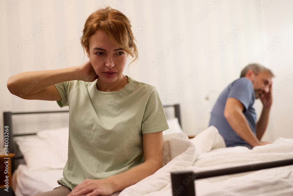 Fototapeta premium Unhappy middle aged couple in bedroom at home