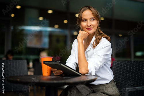 Young businesswoman on a coffee break, smiling