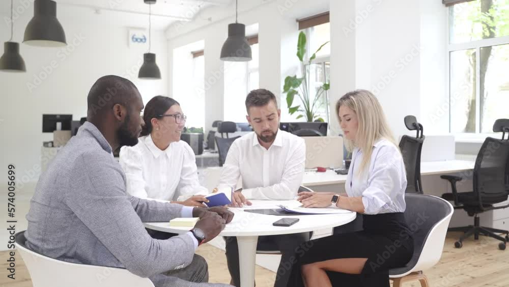 Multi-ethnic business people during meeting in modern office Multi-ethnic business people during meeting in modern office