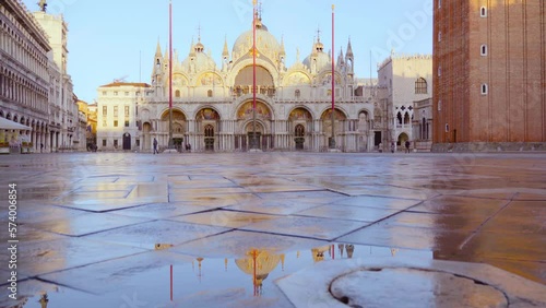 St Mark Basilica cathedral reflects on square rain puddle