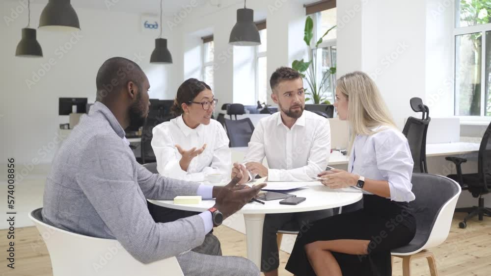 Multi-ethnic business people during meeting in modern office Multi-ethnic business people during meeting in modern office