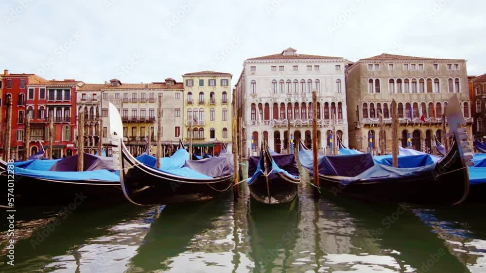 Long wooden gondolas drift on chanel water in Venice city Long wooden gondolas drift on chanel water in Venice city