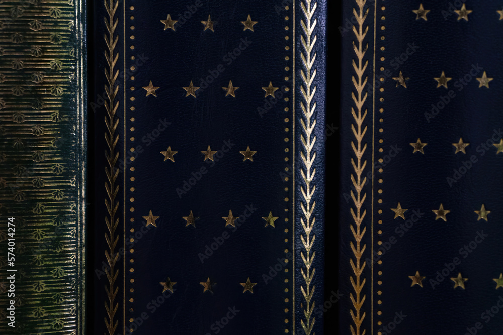 Dark blue covers of old books with golden stars background Dark blue covers of old books with golden stars background