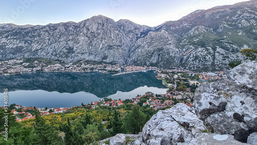 Panoramic view from mountain summit of Sveti Ilija on Kotor bay during sunrise, Adriatic Mediterranean Sea, Montenegro, Balkans, Europe. Fjord winding along steep cliffs. Hiking trail in Dinaric Alps photo