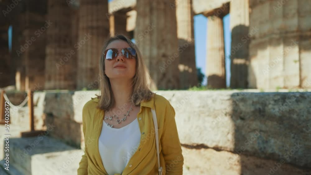 Woman tourist enjoys the views of the old temple. Woman tourist enjoys the views of the old temple.