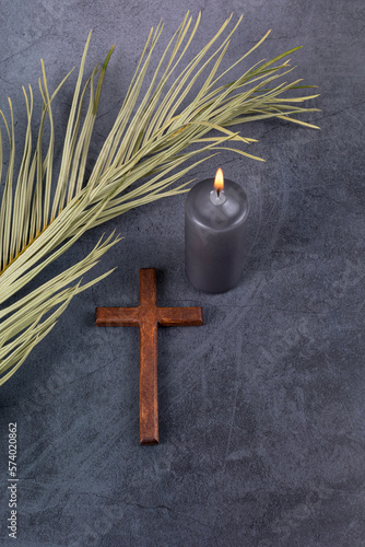 Fototapeta Catholic Cross with palm leaf and burning candle