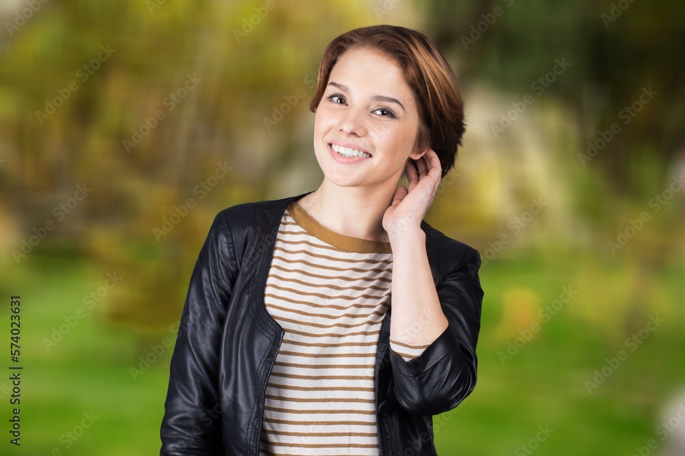 Happy young smart woman posing on outdoor background Happy young smart woman posing on outdoor background