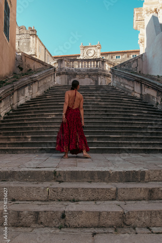 Back of a woman in a dress on Dubrovnik's Jesuit stairs, baroque architecture, Croatia © Lucky Ev