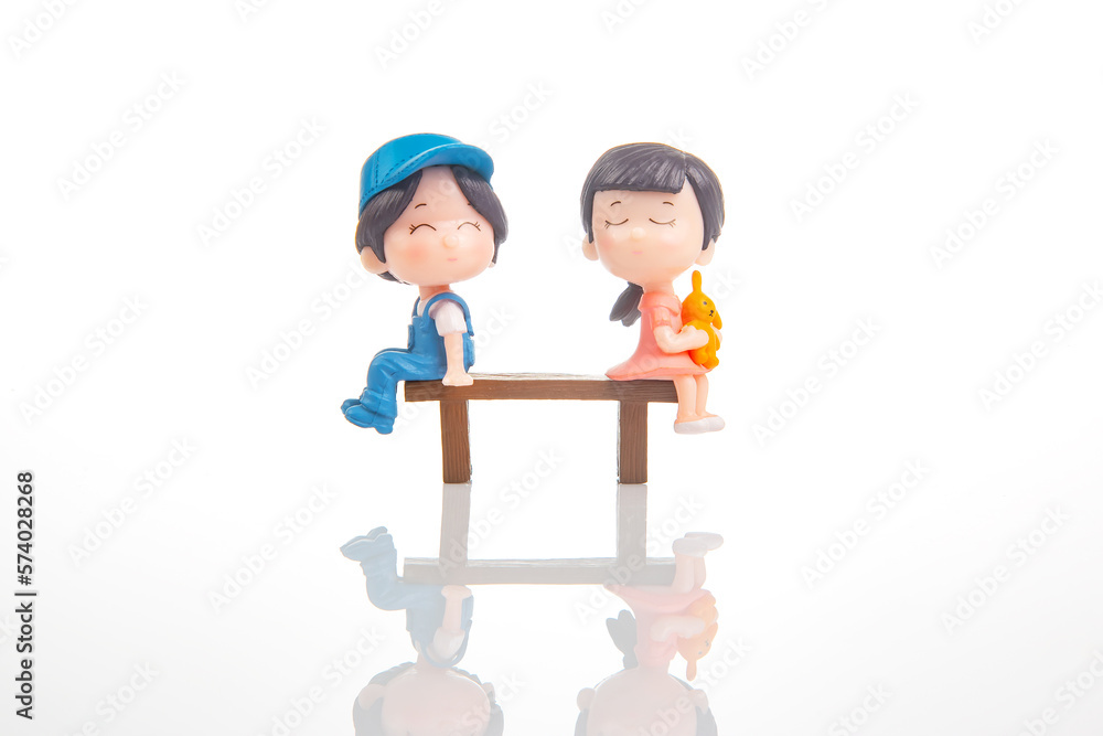 miniature people. figures for the game. romantic couple of young people. Boy and girl sitting on a bench miniature people. figures for the game. romantic couple of young people. Boy and girl sitting on a bench
