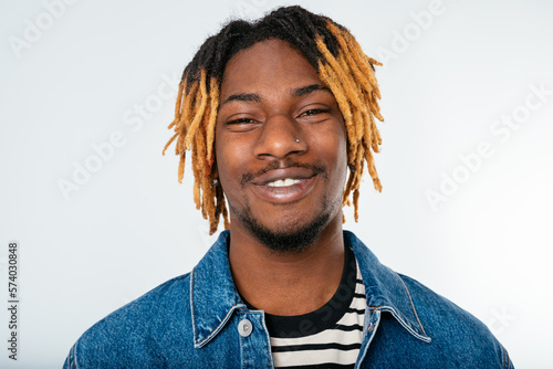 Stylish black man with dreadlocks in denim jacket