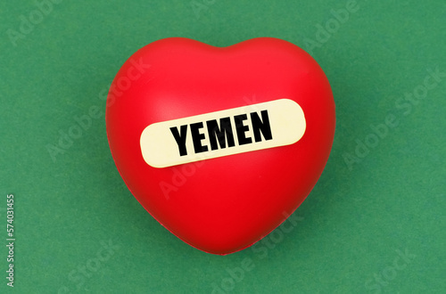 On a green surface lies a red heart with the inscription - Yemen