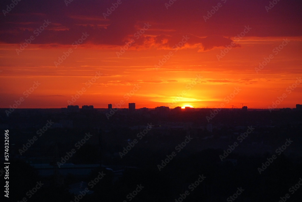 Red sky with clouds over the city, panoramic view.