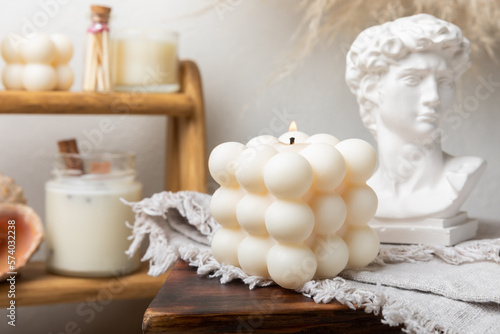 Fotografiet Soy wax candle on a textured table