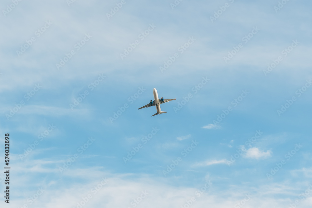 White passenger plane takes off in the sky, amazing clouds in the background. Travel by air White passenger plane takes off in the sky, amazing clouds in the background. Travel by air