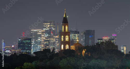 Tel Aviv: Russian Orthodox church and modern skyscrapers at night photo