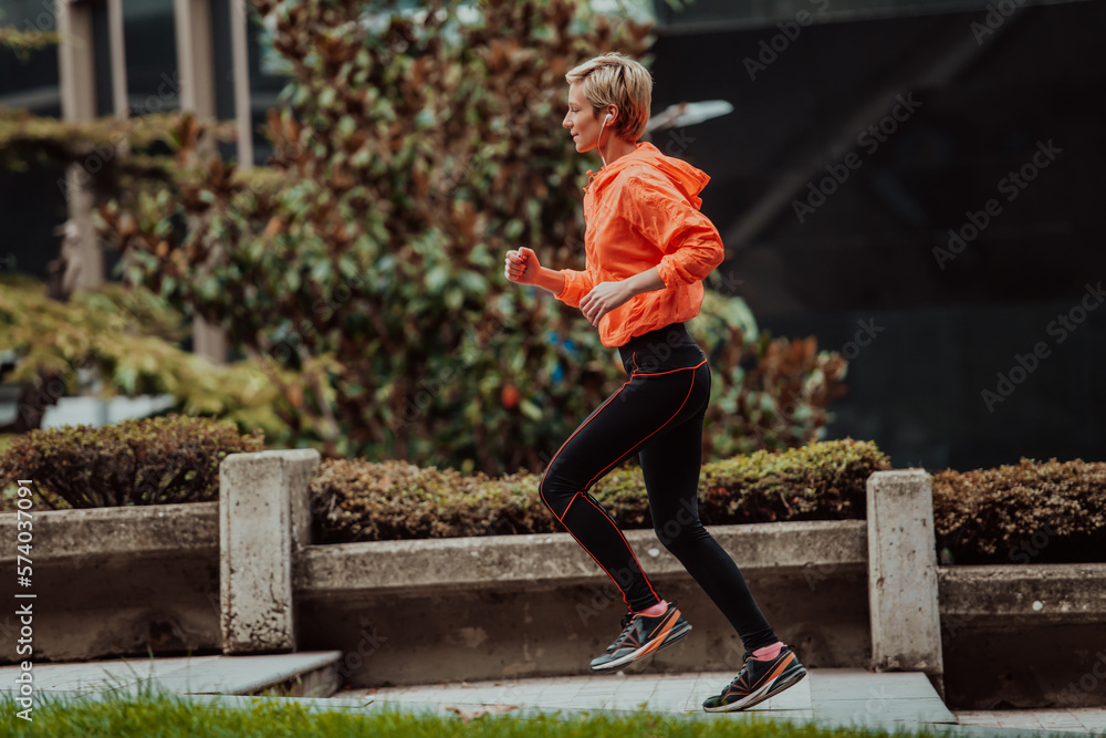 A blonde in a sports outfit is running around the city in an urban environment. The hot blonde maintains a healthy lifestyle. A blonde in a sports outfit is running around the city in an urban environment. The hot blonde maintains a healthy lifestyle.