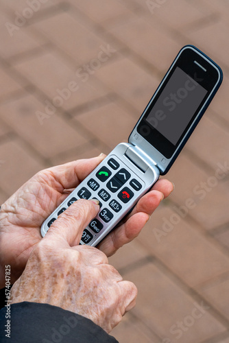 Wallpaper Mural An elderly person using a telephone adapted for elderly people Torontodigital.ca