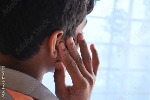 teenage boy having ear pain touching his painful ear , © Towfiqu Barbhuiya 