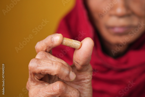 senior hand holding pills with copy space 