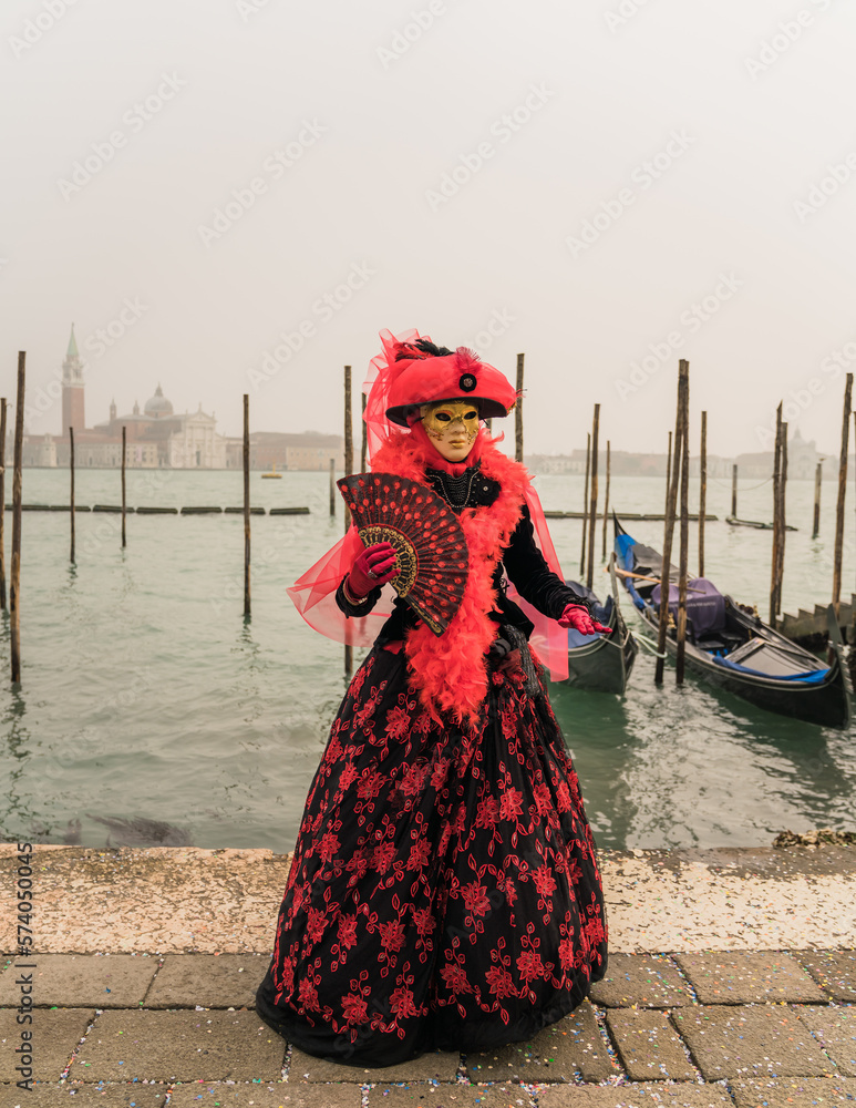 People wearing colorful and elaborate costumes during the Venice carnival in Italy 